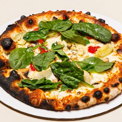 Honeoye Pizza with artichoke hearts, roasted red peppers, mushrooms, and spinach.