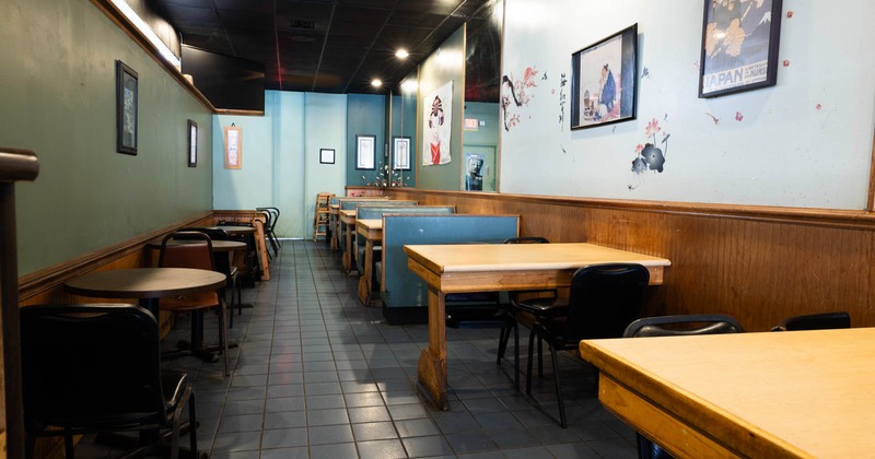 Interior of a quiet casual dining restaurant featuring wooden tables and chairs