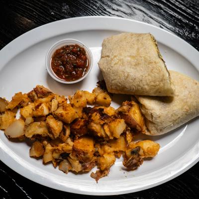 Breakfast burrito with dip and side of roast potatoes.