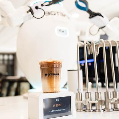 Iced Chocolate latte cup and a robot behind it.