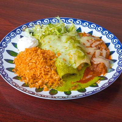 Enchiladas served with a side of Mexican red rice, shredded lettuce and sour cream.