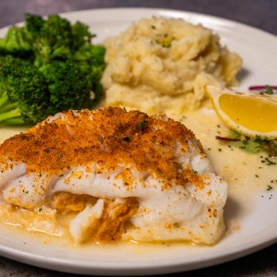Baked Cod fillet served with a side of mashed potatoes and steamed broccoli.