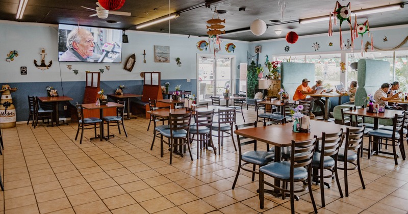 Interior, seating area with few guests in the back