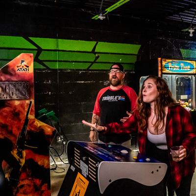 People enjoying arcade video games.