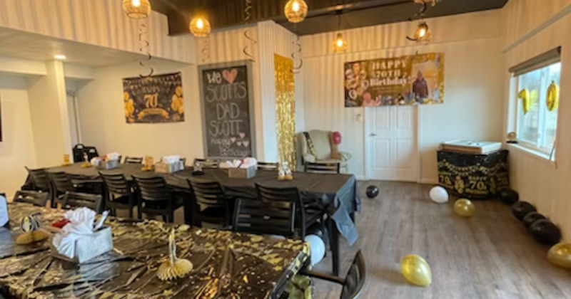 Birthday celebration decorated in a black and gold theme for a "70th" milestone