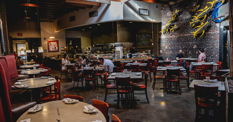 Interior, set dining area with guests enjoying food and drinks