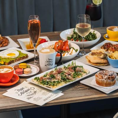Assorted brunch dishes and drinks arranged on a wooden table.