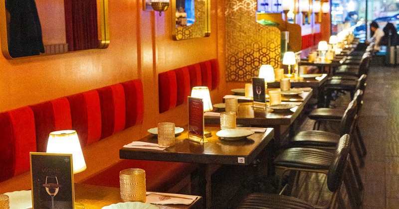 Cozy restaurant interior with set tables along the wall