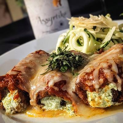 Stuffed rolls, smothered in red sauce and cheese.