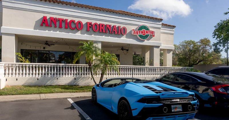 Exterior, front view of restaurant, part of parking lot with sport car