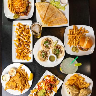 Assortment of food dishes and drinks on a table, overhead view.