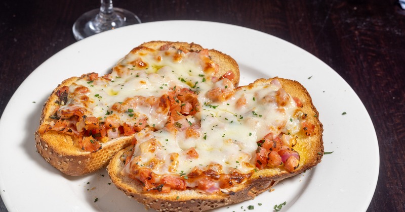 Bruschetta topped with cheese and tomatoes