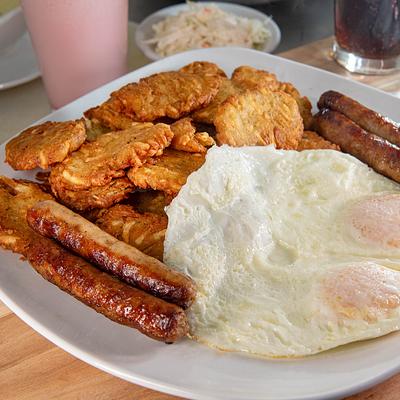 Patato Pancakes with fried eggs and sausages.
