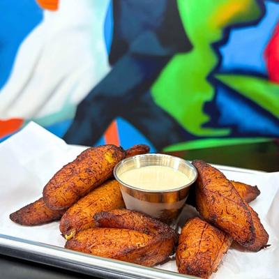 Fried plantains served with creamy dipping sauce.