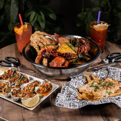 Assortment of dishes served on a table with two cocktails.