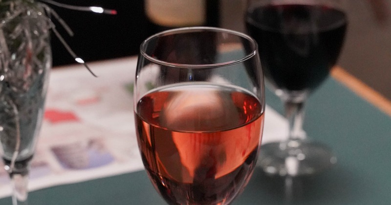 Glass of rose wine with a glass of red wine in the background