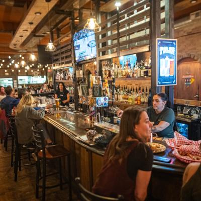 Interior of the bar area with people dining at the bar.