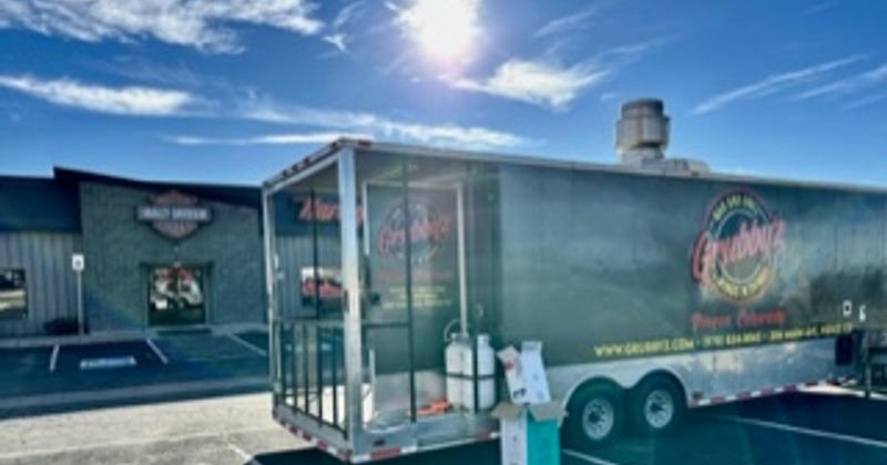 Food truck parked  in a parking lot