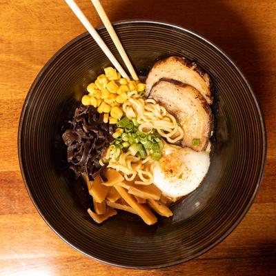 Pork belly ramen, with egg noodles, corn, mushrooms, bamboo shoots, egg, and chili oil.