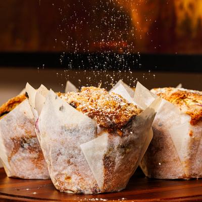 Muffins topped with powdered sugar.
