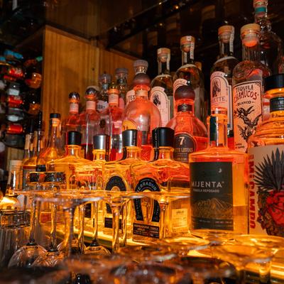 Bar interior, a display of various tequila bottles.