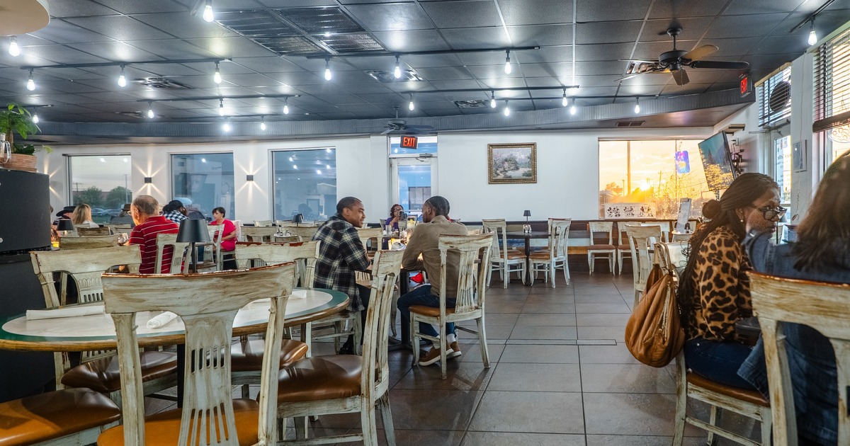 Interior, dining space with white round tables