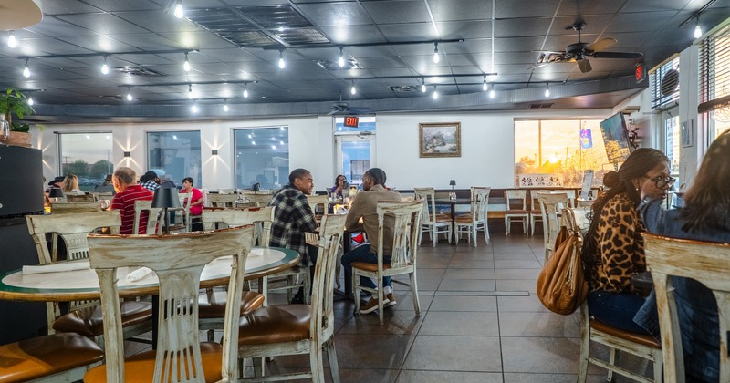 Interior, dining space with white round tables