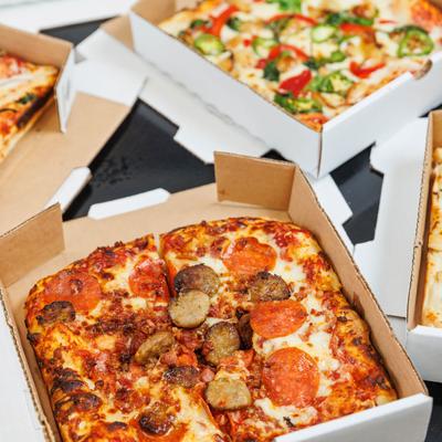 Assorted pizzas displayed on a table.