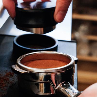 A hand preparing a latte.