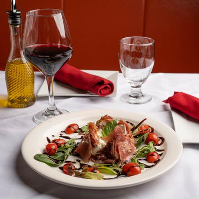 Burrata cheese and prosciutto salad, with cherry tomatoes, basil, and balsamic.