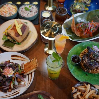 Various dishes served on the table with drinks.