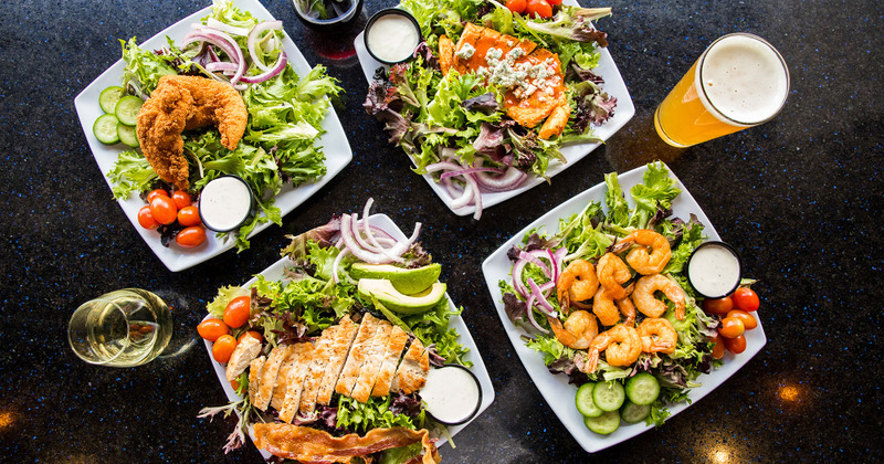 Multiple salad plates and drinks, flat lay view