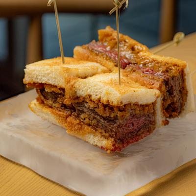 Wagyu Sandwich featuring a panko-breaded beef cutlet and a white toast.