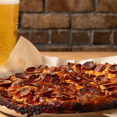 Pepperoni pizza with beer, side view.