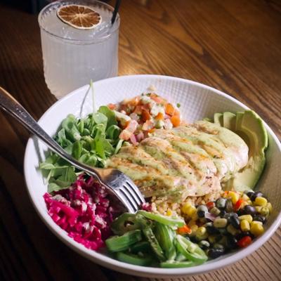 Chicken Fiesta Bowl served on the table with a cocktail.