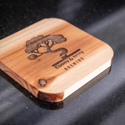 Wooden coaster with the company logo.