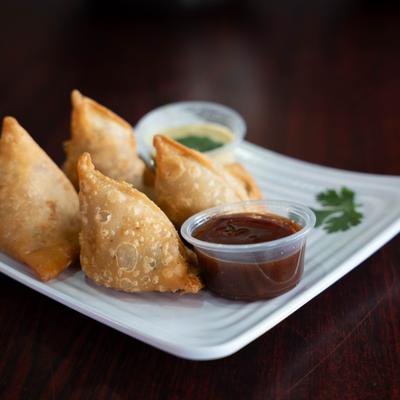 Crispy samosas, with dipping sauces.