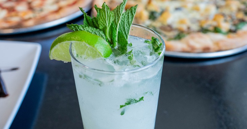 Mojito cocktail with mint and lime garnishes, close-up