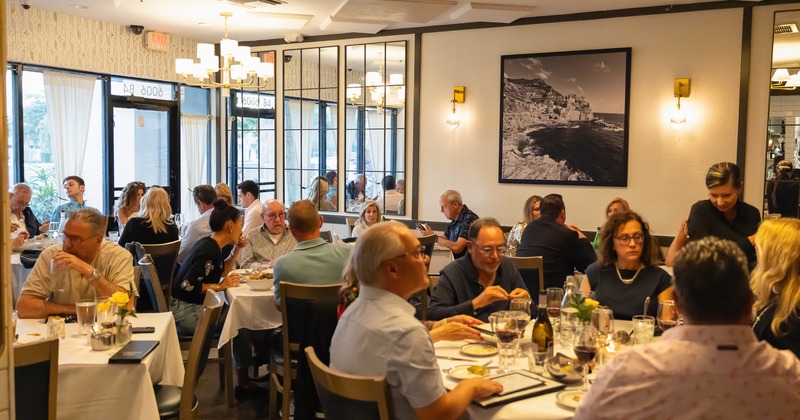 Cozy interior dining area full of guests enjoying their food and drinks