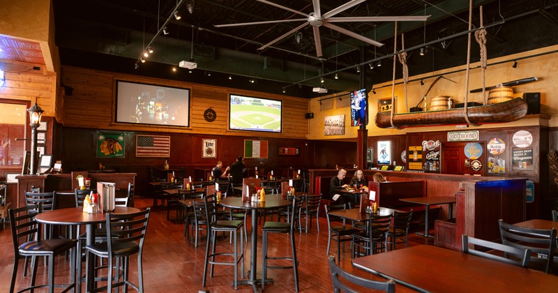Spacious sports bar with a warm and rustic interior seating area
