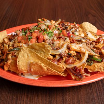 Nachos topped with steak , bacon, chorizo, onions, jalapenos and pico de gallo.