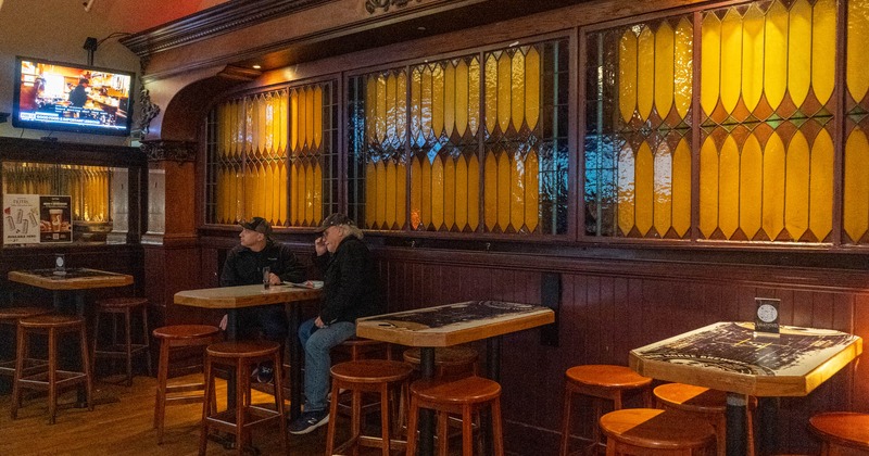 Interior, bar tables and chairs, tv screen on the wall
