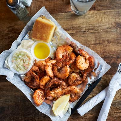 Shrimp Boil served with coleslaw, corn bread and melted butter.