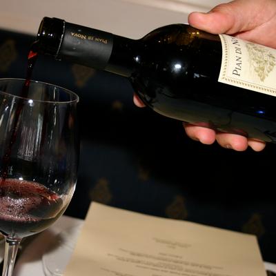 Red wine being poured into a glass.