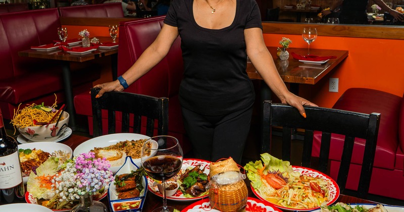 Person posing behind the table featuring a variety of dishes