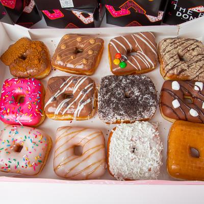 A tray of colorful square-shaped donuts.
