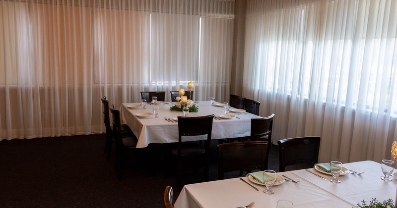 Interior, tables with white clothes and chairs