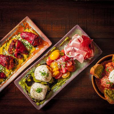 Assorted appetizers arranged on wooden serving boards.