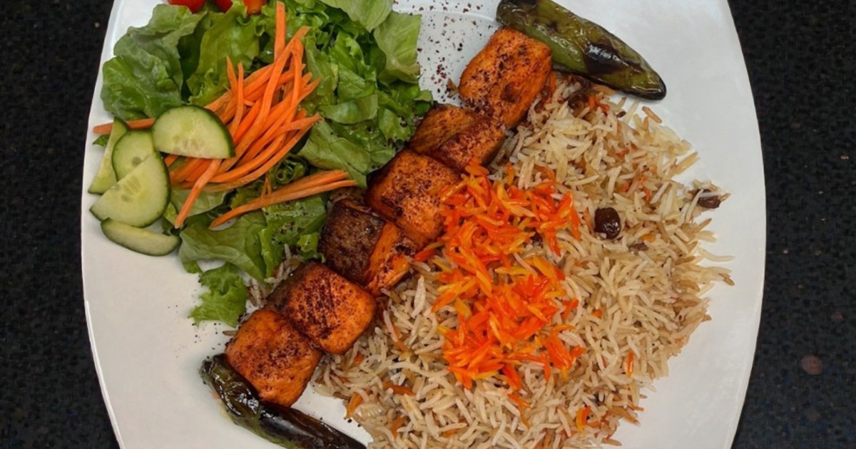 Grilled salmon kebab with seasoned rice and fresh salad
