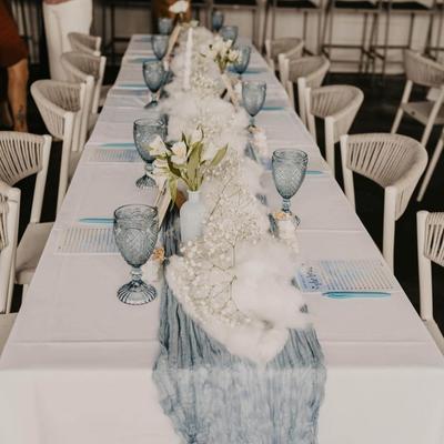 Decorated event table with glasses, menus and decorations.